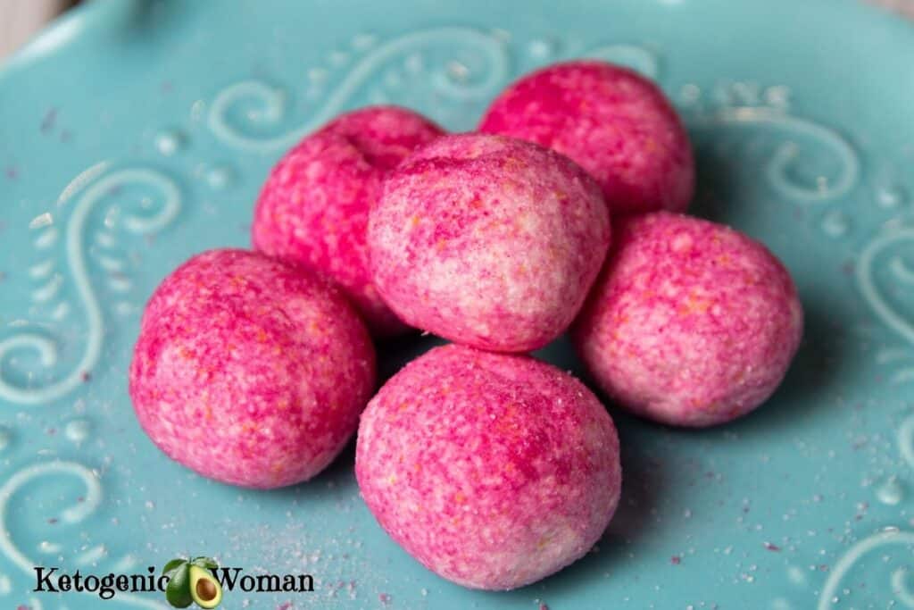 Pink Raspberry Jello Balls arranged on blue plate