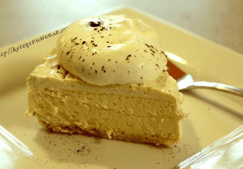 A piece of cheesecake and whipped cream on a plate