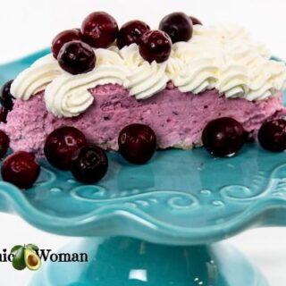 Cranberry mousse with whip cream on blue plate