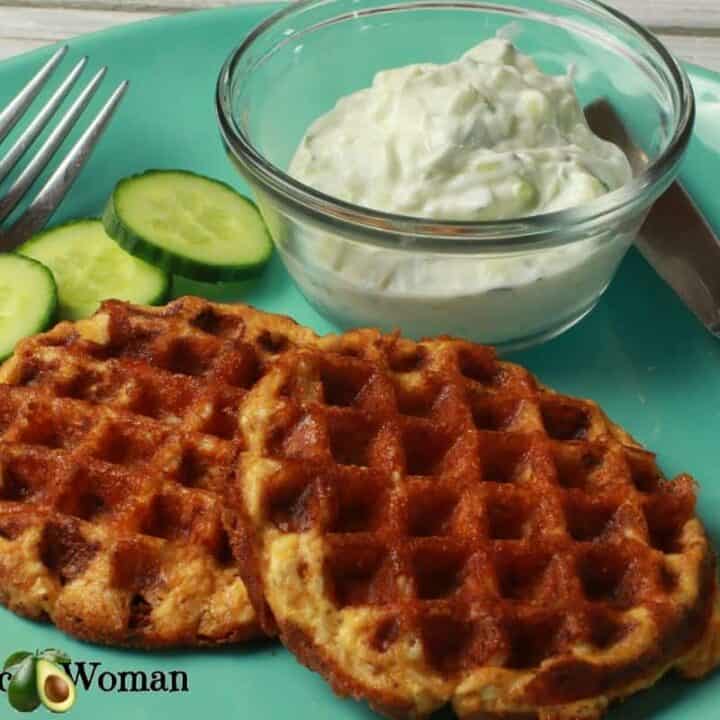 Butter chicken chaffles with sauce and cucumbers on a blue plate