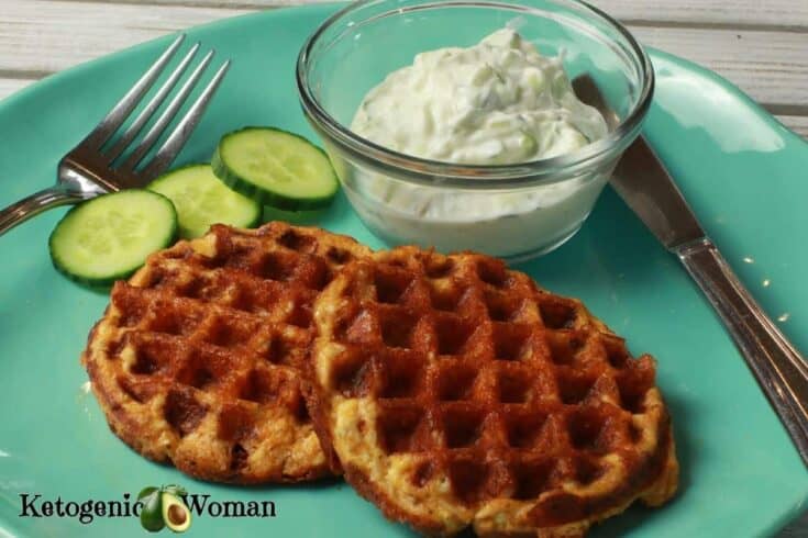 Butter chicken chaffles with sauce and cucumbers on a blue plate