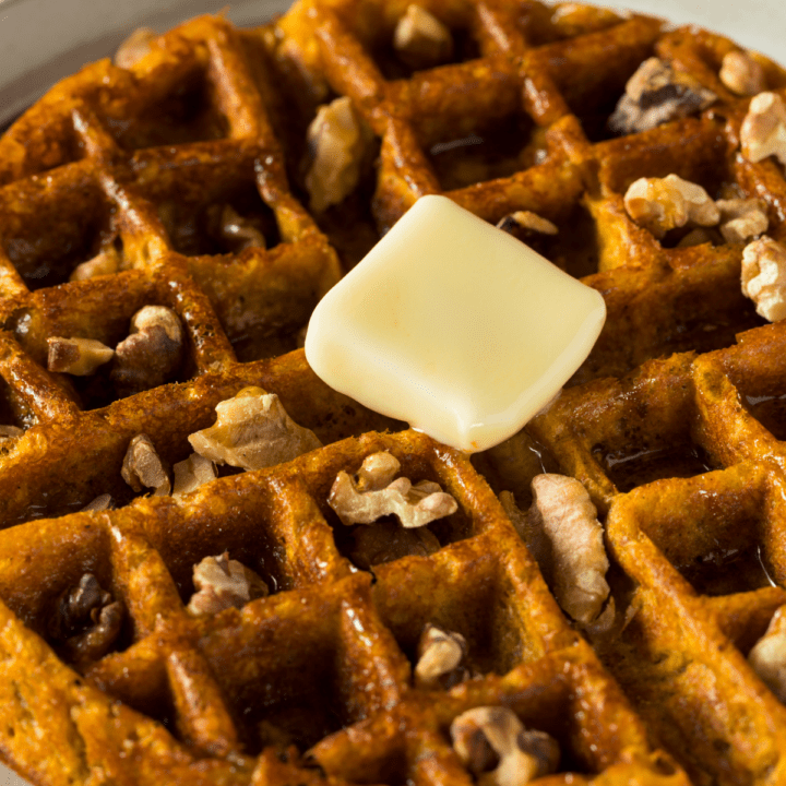 Keto Pumpkin Spice Waffles topped with butter and walnuts