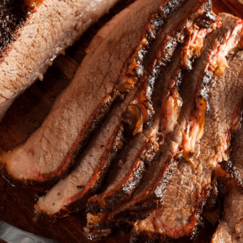 Cooked Brisket Slices on Wooden Board