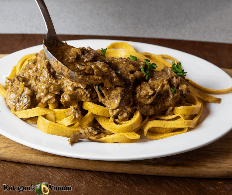 Beef Stroganoff being served with large spoon