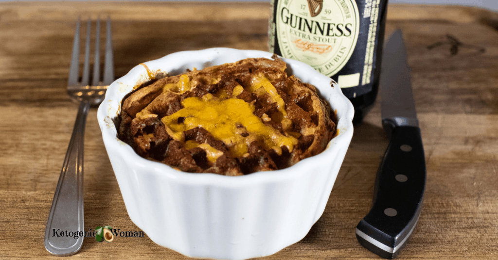 Keto Meat Pie on wooden board with bottle of stout