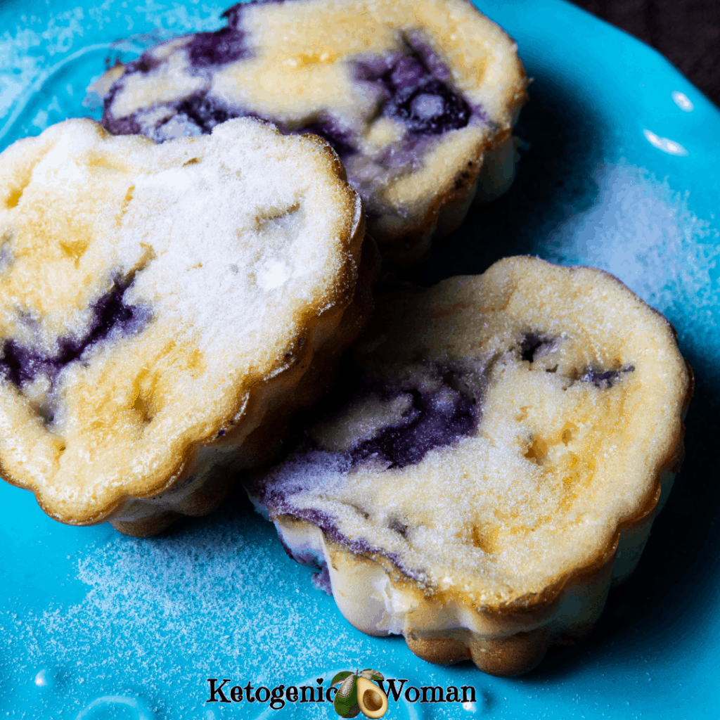 cream cheese muffins with blueberries on blue plate