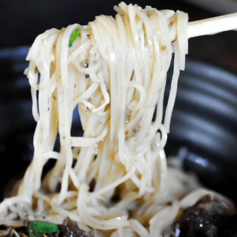 Noodles in black bowl